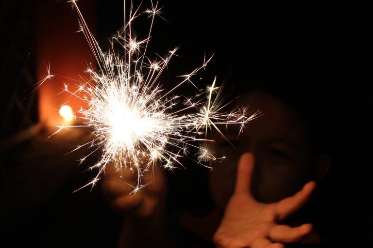 a person holding sparklers