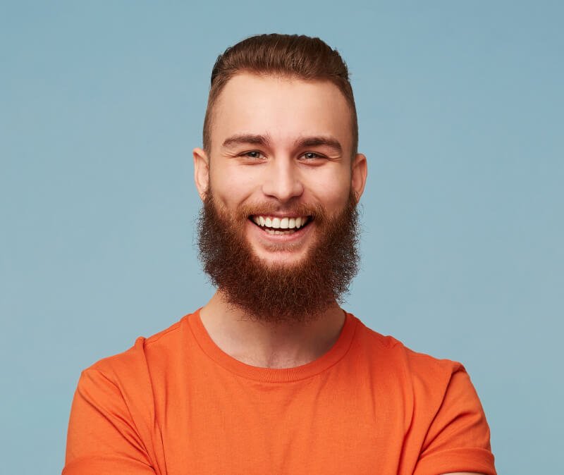 a man with a beard smiling